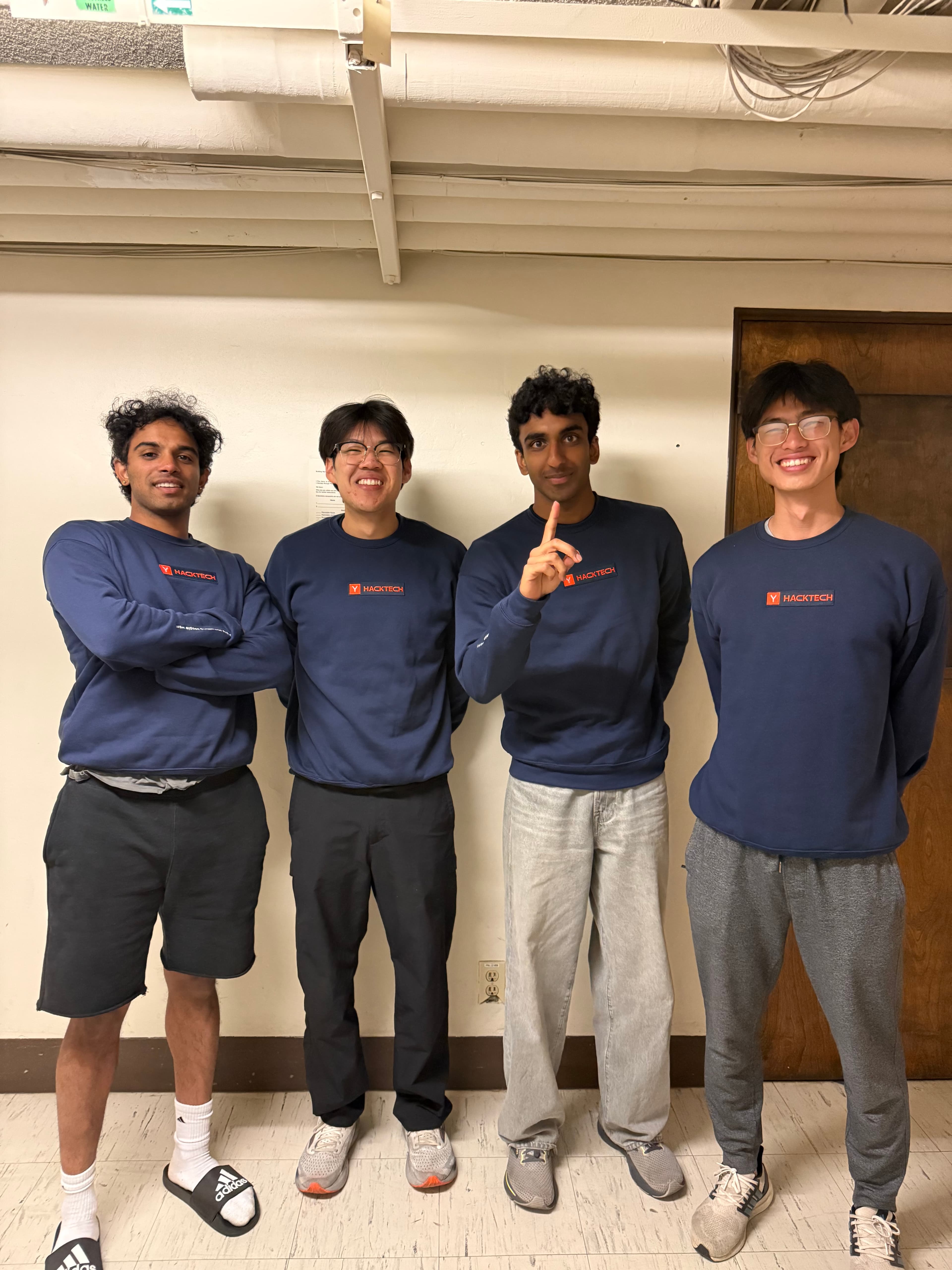 Jethro Chu (second from left) and his four-person engineering team wearing navy HackTech crewnecks after winning 4th place at Caltech's HackTech hackathon for building Lab Logger